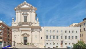 a large white building with a tall tower at Holidayhouse in Civitavecchia