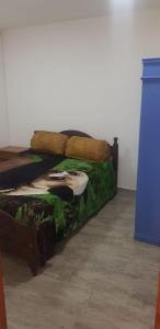 a bed sitting in a room next to a blue cabinet at CaSa VALENTINA in San Clemente del Tuyú
