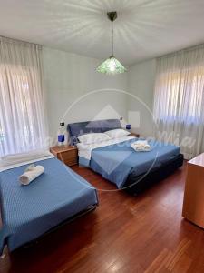 a bedroom with two beds and a light at Villa Viviana con Piscina "UnaNotteaCasaMia" in Sacrofano +15 photos