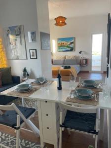 a living room with a table with plates on it at Casa Del Encanto Arcos in Arcos de la Frontera