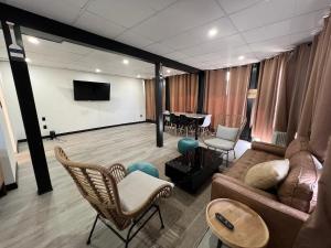 a living room with a couch and chairs and a table at Harborside Suites in Yarmouth