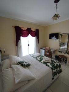 Cama ou camas em um quarto em Hotel Rio Penedo
