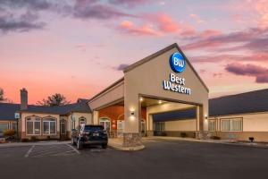 a building with a best western sign in a parking lot at Best Western Chambersburg in Chambersburg
