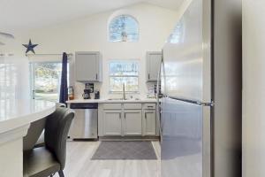 a kitchen with white cabinets and a refrigerator at The Par-fect Getaway in Haines City