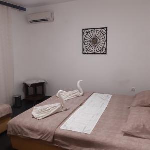 a bedroom with a bed with a clock on the wall at Marko Apartment in Sutomore