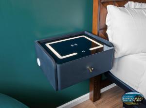 a blue nightstand with a drawer next to a bed at The Eastpoint Suite #1 in Lake Geneva