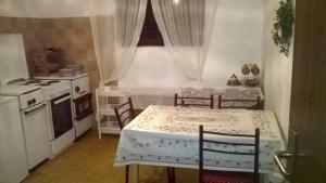 a kitchen with a table and two chairs and a stove at Marko Apartment in Sutomore +41 photos