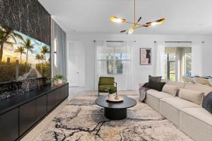 a living room with a couch and a table at SUPER GIANT - 12BD 12BAs - SLEEP 38 & NEAR DiSNEY in Kissimmee