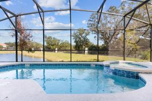 an indoor swimming pool with a large glass walled in at SUPER GIANT - 12BD 12BAs - SLEEP 38 & NEAR DiSNEY in Kissimmee