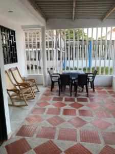 a patio with a table and chairs in a room at Casa LAGOMAR in Puerto Colombia