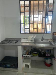 a kitchen with a sink and a stove at Casa LAGOMAR in Puerto Colombia