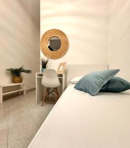 una camera da letto con un letto con specchio e una sedia di A Due Passi dal Mare B&B a Scalea