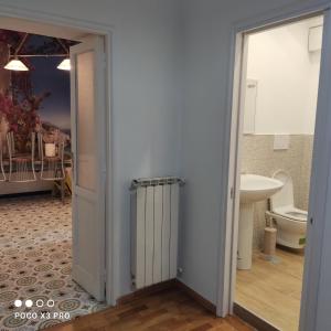 a bathroom with a toilet and a door and a sink at Residenza Regina Margherita in Castellammare di Stabia
