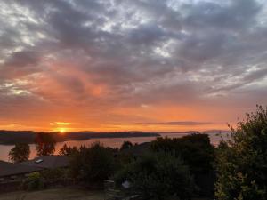 a view of a sunset from the roof of a house at Ladysmith Harbour View House in Ladysmith