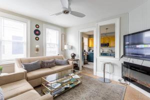 a living room with a couch and a tv at Revamped 3BR Apt with Easy Check-In Family-Friendly in Bridgeport