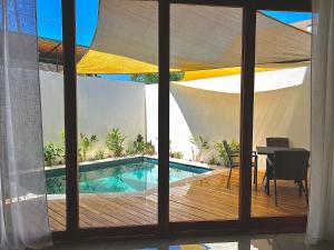 a view of a swimming pool through a window at Casa María - Playa hermosa Cóbano in Playa hermosa