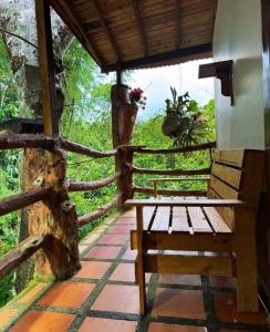 a wooden bench sitting on a porch with a fence at Los micos in San Rafael +16 photos
