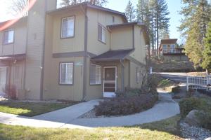 a house with a driveway in front of it at Bearadise At North Shore Free Night Special in Bass Lake