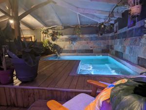 a hot tub in a tent with a wooden deck at Insolite Bois Cailloux avec Spa in Saint-Remèze