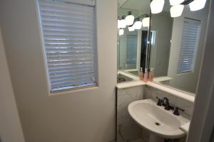 a white bathroom with a sink and a mirror at Bearadise At North Shore Free Night Special in Bass Lake +20 photos