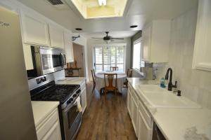 a kitchen with white cabinets and a stove top oven at Bearadise At North Shore Free Night Special in Bass Lake