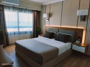 a bedroom with a large bed and a window at Delmar Hotel Matrouh in Marsa Matruh