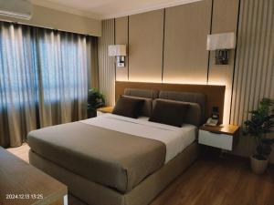 a bedroom with a large bed in a hotel room at Delmar Hotel Matrouh in Marsa Matruh