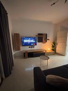 a living room with a flat screen tv on the wall at Sliema Penthouse 3 Ensuite Bedrooms Seaview - Zero55 in Sliema