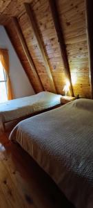 a bedroom with two beds and a wooden ceiling at Alpes San Rafael in San Rafael