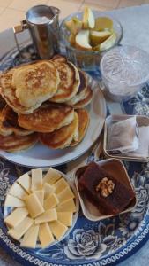 a table with plates of pancakes and cheese and apples at Alpes San Rafael in San Rafael
