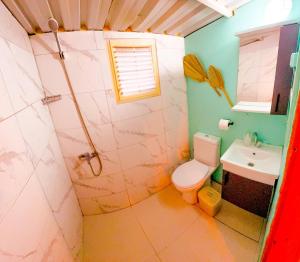a bathroom with a toilet and a sink at Turkuaz Bungalows in Cıralı