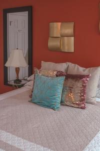 a bedroom with a bed with pillows and a lamp at Vacation Home in Morrow, Georgia - Casa Bustamante in Morrow