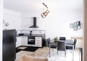 a kitchen with a black refrigerator and a table at Grammy's room 1 in Karpenisi