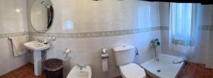 a small bathroom with a toilet and a sink at CASA A BARCELA en San Vicente de O Grove in San Vicente de O Grove +11 photos