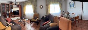 a living room with a couch and chairs and a table at CASA A BARCELA en San Vicente de O Grove in San Vicente de O Grove