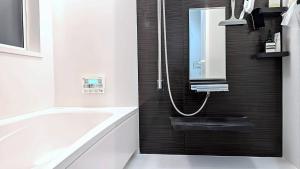 a bathroom with a bath tub and a sink at UND STAY Premium Luxury Vacation 別府 鉄輪 in Beppu +58 photos