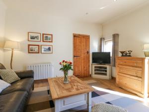 a living room with a couch and a table at The Old Dairy in Herne Bay