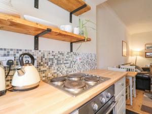 a kitchen with a stove top oven next to a counter at The Old Dairy in Herne Bay