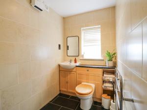 a bathroom with a toilet and a sink and a mirror at The Old Dairy in Herne Bay +16 photos
