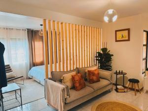 a living room with a couch and a bed at Dani House - Porto Moniz Escape in Porto Moniz