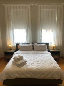 a bedroom with a large bed with towels on it at Utopia Konak Otel in Bozuyuk