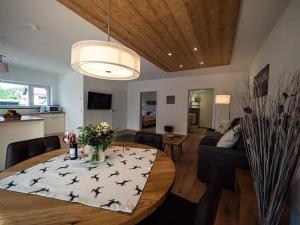普夫龙滕Ferienwohnung Tennenglück - Haus Alpentenne, Pfronten的一间带桌椅的餐厅和客厅