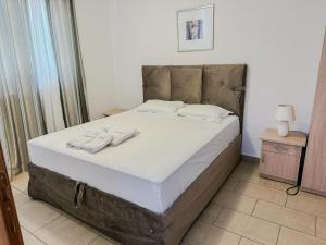 a bedroom with a bed with two towels on it at Villa Andjelina in Budva +37 photos