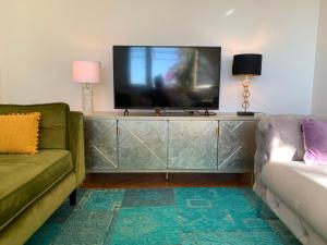 a living room with a flat screen tv on a dresser at Multiverse in Podstrana