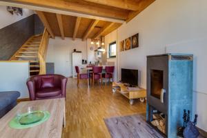 a living room with a couch and a fireplace at LAGOVIDA Hafenhaus d am Störmthaler See in Großpösna +27 photos