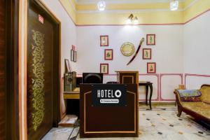a hotel entrance with a hotel sign in a room at Super Hotel O Sikar Road Jaipur Formerly Garg Niwas in Jaipur
