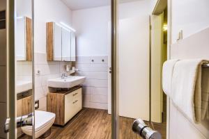 a small bathroom with a sink and a toilet at LAGOVIDA Möwenblick c am Störmthaler See in Großpösna