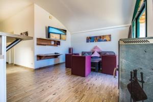 a living room with wooden floors and white walls at LAGOVIDA Dünenhaus Comfort i am Störmthaler See in Großpösna