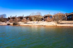 a view of a river with a bridge in the background at LAGOVIDA Dünenhaus Comfort Familia c am Störmthaler See in Großpösna