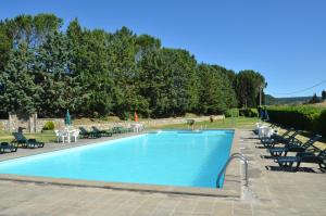 a large swimming pool with chairs and tables at Agriturismo Sant'Angelo in Acquapendente +55 photos